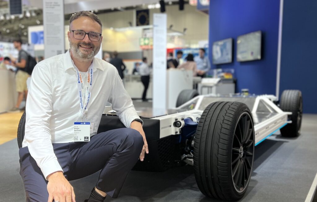 Ansgar Gerlicher in front of FlexCAR platform at Hannover Trade Show 2022